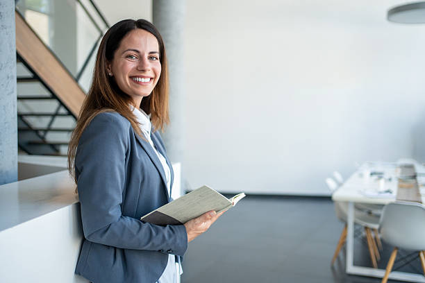 istock Smiling businesswoman holding notebook in modern office 2226177463