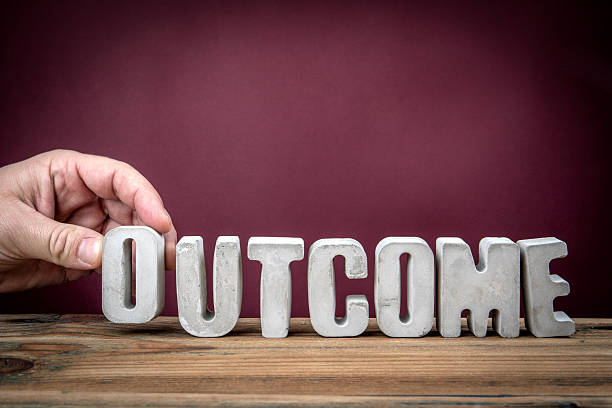 istock OUTCOME Word Created from Concrete Alphabet Letters on Wooden Desk 2226177724