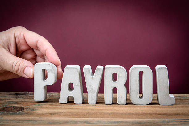 istock PAYROL Word Created from Concrete Alphabet Letters on Wooden Desk 2226177741