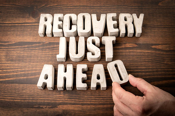 istock RECOVERY JUST AHEAD. Concrete alphabet letters on a wooden texture background 2226177761