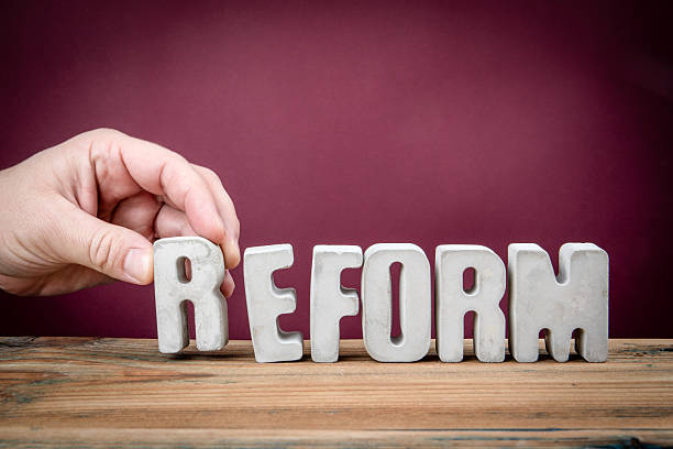 istock REFORM Word Created from Concrete Alphabet Letters on Wooden Desk 2226177766