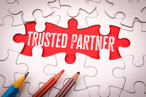 istock Trusted Partner. White puzzle pieces and colored pencils 2226177769