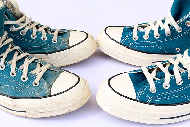 istock Old vs new turquoise sneakers, white background, with copy space 2226178884