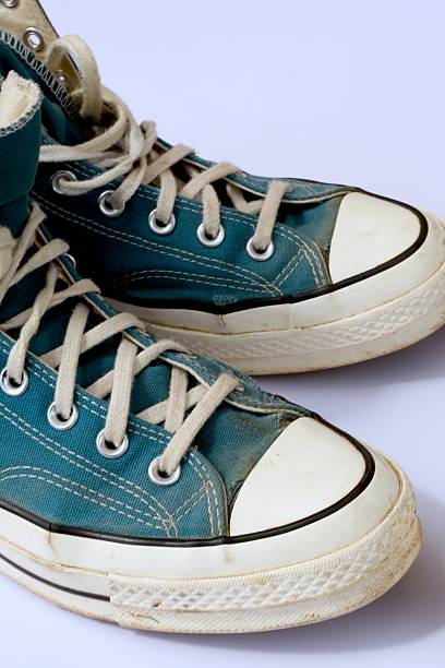 istock A pair of old dark turquoise sneakers, white background 2226178892