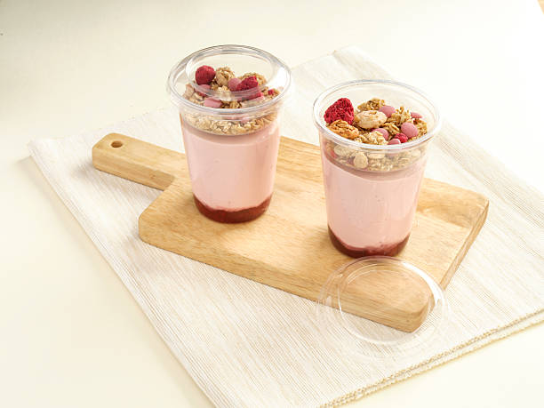 istock Strawberry Greek Yogurt Parfaits with Ruby Chocolate in cup on wooden board side view of light dessert 2226179011