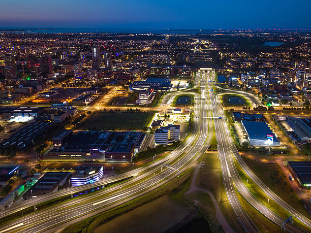 istock Illuminated highway interchange and city lights at night, Amsterdam South 2226184311