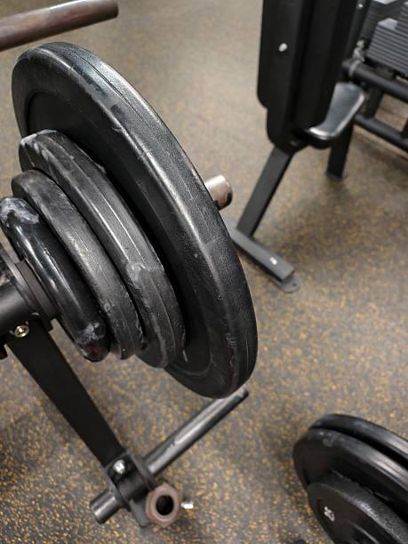 istock Several black weight plates on a rack in gym 2226184328