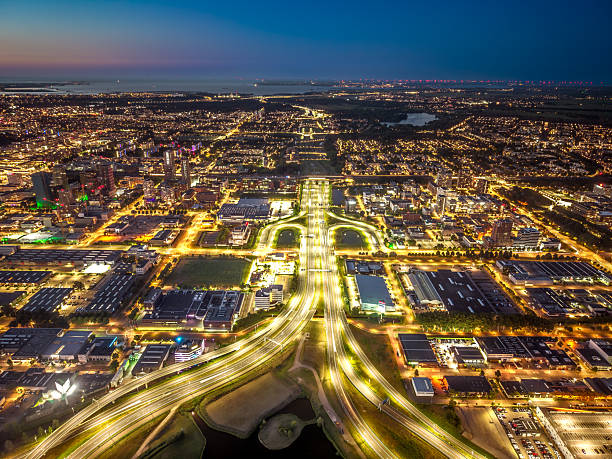 istock Illuminated highway interchange and city lights at night, Amsterdam South 2226184353