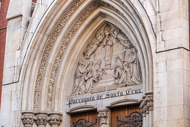 Madrid, Spain. Tympanum of the Iglesia de Santa Cruz, featuring a high relief depiction of the Exaltation of the Holy Cross and a Latin inscription reading Exaltatio Crucis