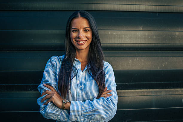 istock Confident young businesswoman smiling with folded arms 2226189819