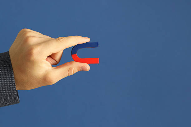 istock Man holding horseshoe magnet on blue background, closeup. Space for text 2226193628