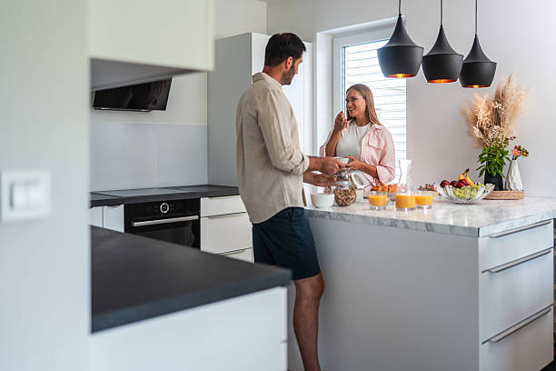 istock Happy Couple Preparing Breakfast Together in Modern Sunlit Kitchen 2226194536