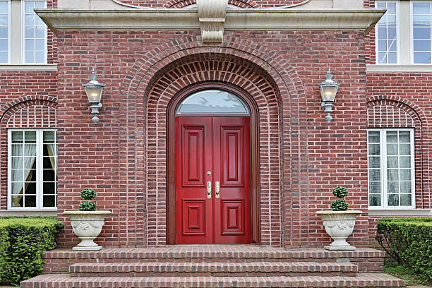 Entrance to brick house with maroon colored double door