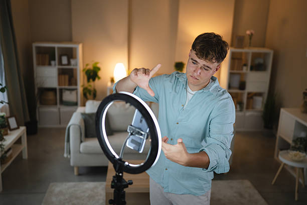istock man v-logger set up mobile phone and ring light for live streaming 2226201064