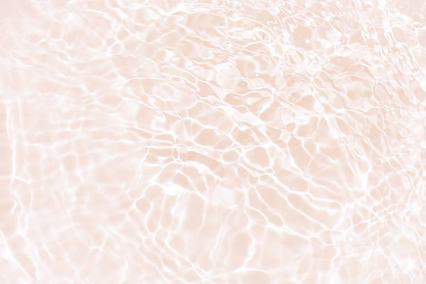 istock Pink water bubbles on the surface ripples. Defocus blurred transparent pink colored clear calm water surface texture with splash and bubbles. Water waves with shining pattern texture background 2226201403