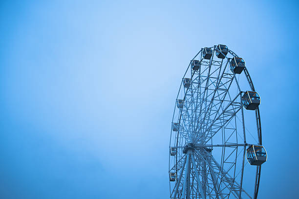 Giant Observation Wheel Stands Tall Against a Moody Blue Sky at Twilight.