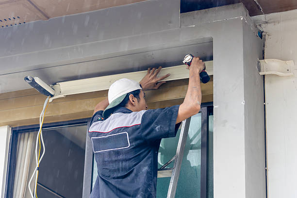 istock Worker using drill to install air conditioner, Man working in rainy day, Air conditioning technicians install new air conditioners in home 2226206328
