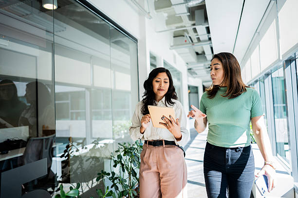 istock Coworkers talking and walking at office 2226206427