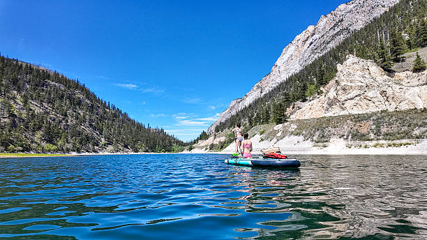istock Young girls relax on inflatable raft on mountain lake 2226206865