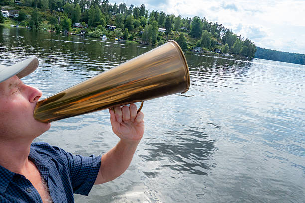 Stockholm, Sweden A man uses a foghorn to scream out a message.