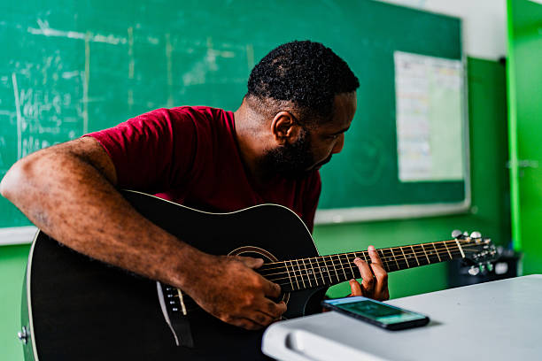 Man hands playing acoustic guitar, close up guitar player Musical instrument for recreation or hobby passion