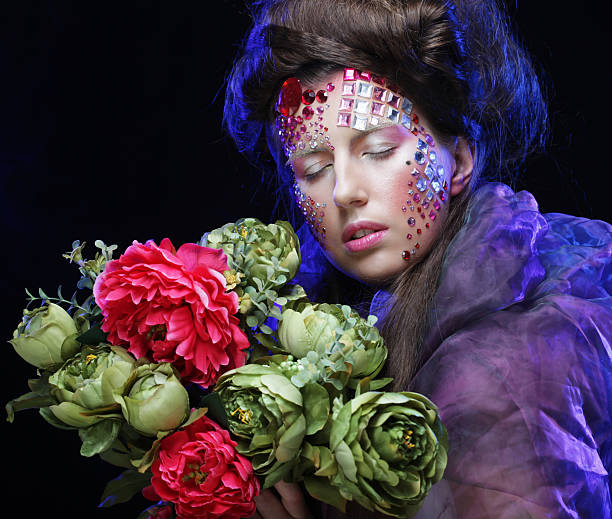 istock woman in creative image  with big flowers. 2226213040