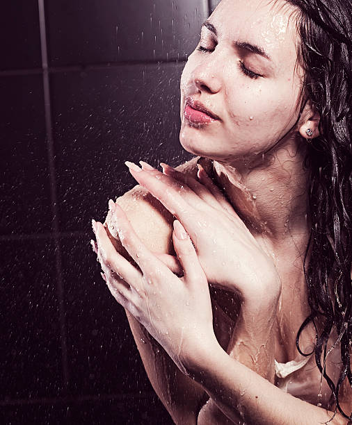 young cute curly girl taking a shower