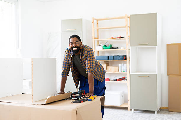 istock Carpenter smiling while building furniture in workshop 2226213455