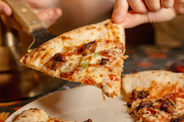 istock A Delicious Slice of Pizza Being Lifted with a Server 2226223240
