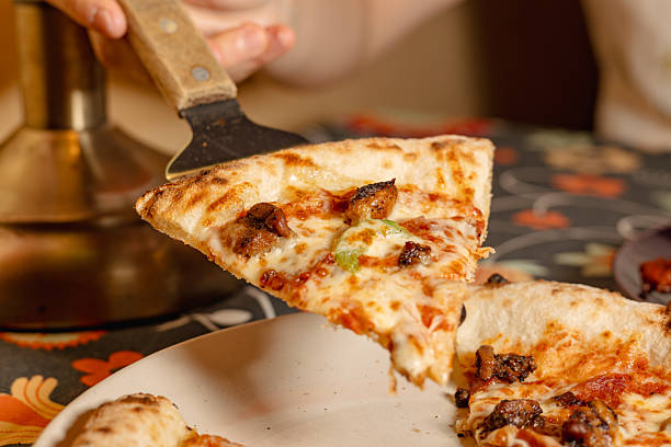 istock A Delicious Slice of Pizza Being Served with a Spatula 2226223305