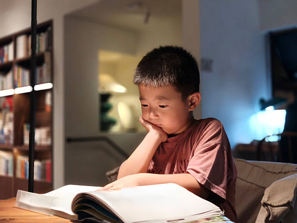 istock A child is sitting on the sofa at home reading a picture book 2226224198