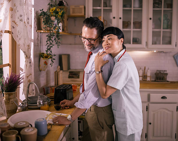 couple enjoying coffee together after a long workday , hugging