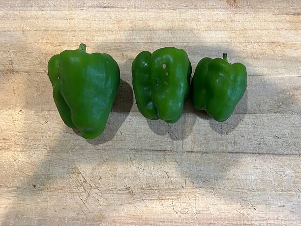 istock Green pepper on a wooden cutting board 2226234318