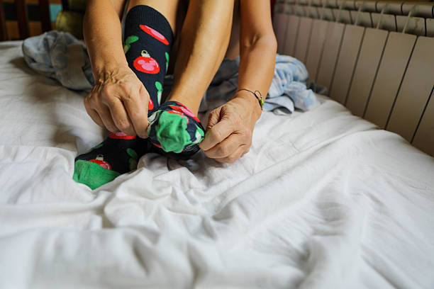 istock Female Feet and Hands in Dressing Moment 2226240787