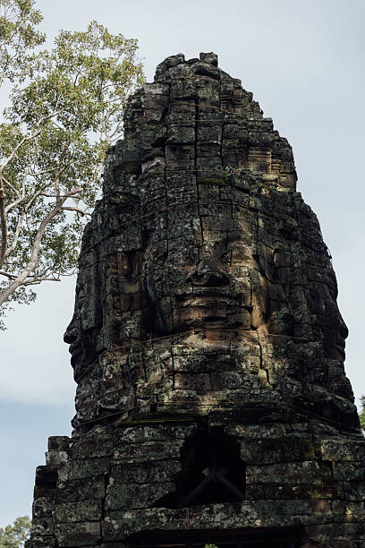 Looking through a stone archway at the iconic faces of the Bayon Temple, Siem Reap, Cambodia