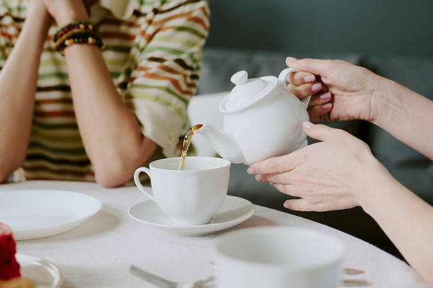 istock Caucasian Woman Pouring Tea during Gathering 2226241436