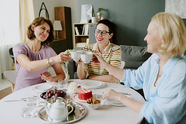 istock Three Middle Aged Caucasian Women Smiling While Toasting with Teacups Indoors 2226241630