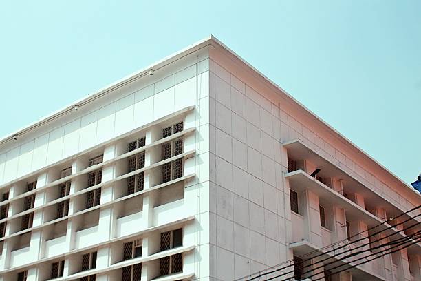 istock White Geometric Facade in Bright Sunlight. old building and blue sky 2226242637