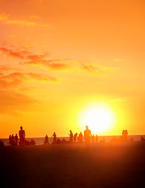 istock Crowd of people enjoy on sandy tropical beach during sunset 2226244881