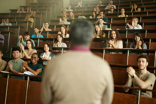 istock Happy university students applauding on a class at lecture hall. 2226245690