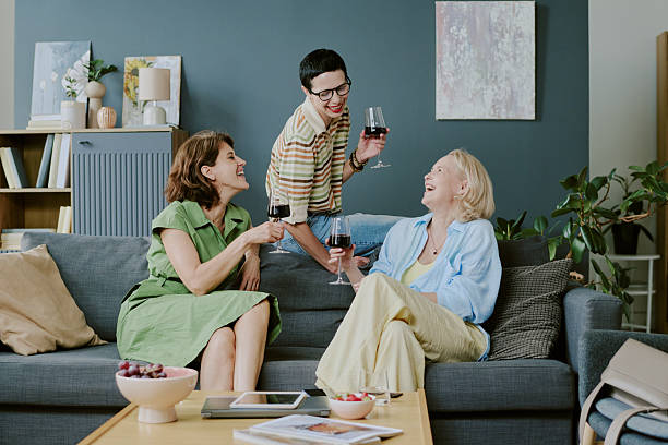 istock Three Women Socializing and Laughing While Drinking Red Wine 2226246478