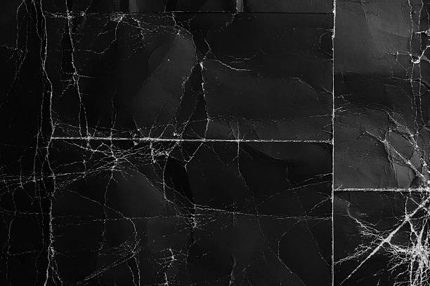 istock Aged folds and worn wrinkles on a black distressed cardboard surface 2226246558