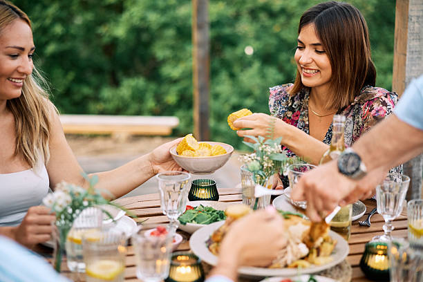 istock Friends Sharing Homemade Meal Outdoors on Vacation 2226246601