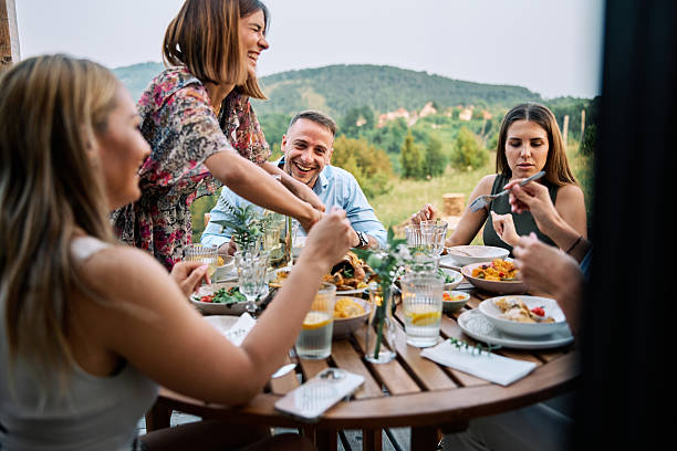 istock Friends Enjoying Meal Outdoors on Vacation In Nature 2226247909