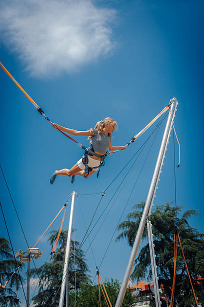 istock Girl jumping on bungee trampoline having fun in amusement park 2226248577