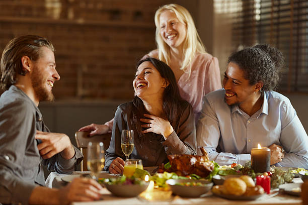 istock Happy diverse friends enjoying in lunch at dining table. 2226251523