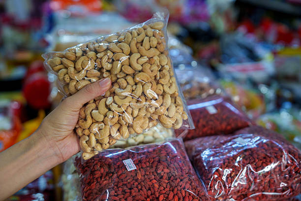 istock Hand Holding Packaged Cashew Nuts at Local Market 2226253191