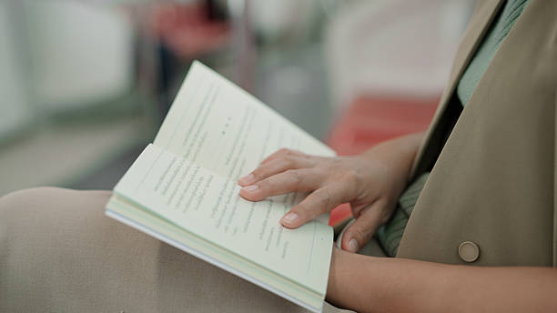 istock Asian woman reading a book while sitting on train 2226256786