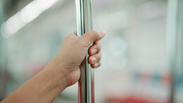 istock Asian woman holding handrail while commuting by sky train 2226256885