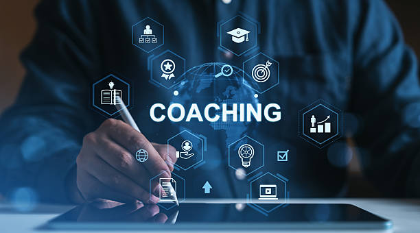 istock Coaching concept with business icons surrounding a man using a stylus on digital tablet, symbolizing mentoring, learning, and career growth in blue tone style. 2226257242